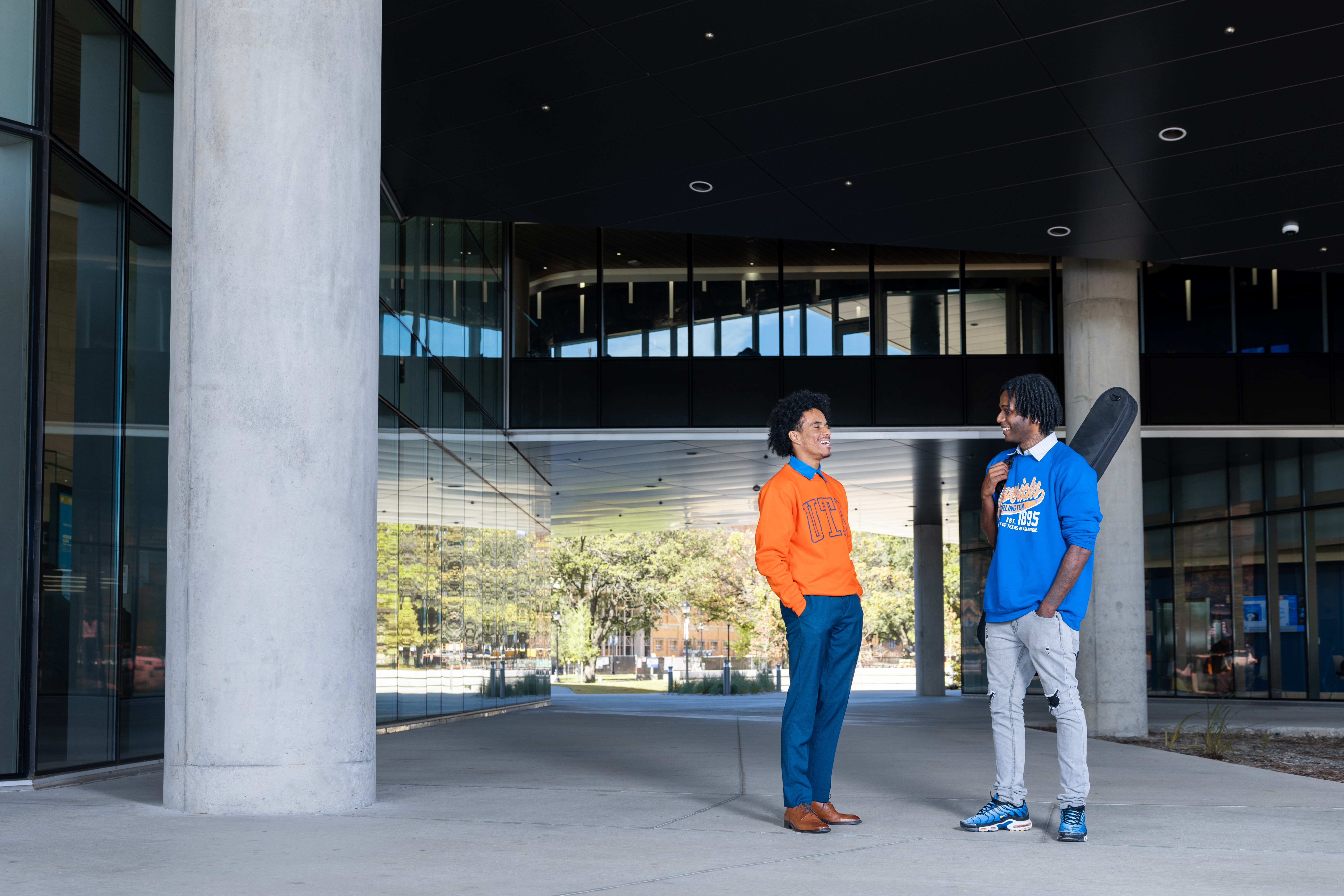 Two people standing in front of a building